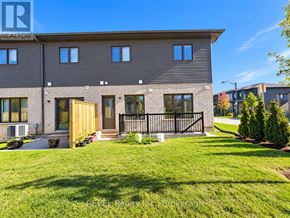 Niagara Falls (Cherrywood) townhouse for rent - A modern house with a grey facade and a black gate.
