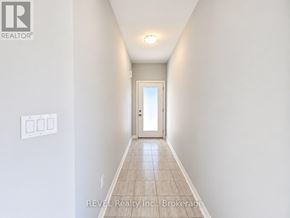 Niagara Falls (Cherrywood) townhouse for rent - A hallway with a door at the end and a light on the ceiling.