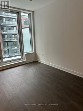 Toronto (Regent Park) condo for rent - A room with a large window and a view of a building across the street.
