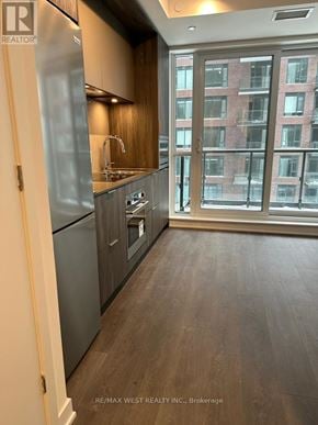 Toronto (Regent Park) condo for rent - A kitchen with a refrigerator, sink, and stove.