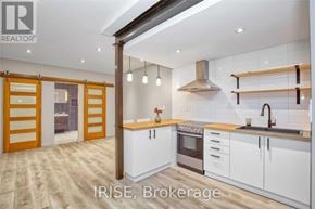 Toronto (Oakwood Village) apartment for rent - A modern kitchen with white cabinets and a wooden floor.