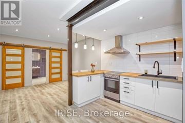 Toronto (Oakwood Village) apartment for rent - A modern kitchen with white cabinets and a wooden floor.