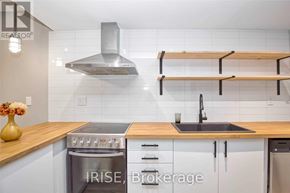 Toronto (Oakwood Village) apartment for rent - A modern kitchen with a stove top oven and a double sink.