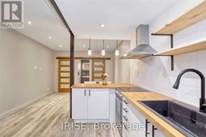 Toronto (Oakwood Village) apartment for rent - A modern kitchen with white cabinets and a wooden countertop.