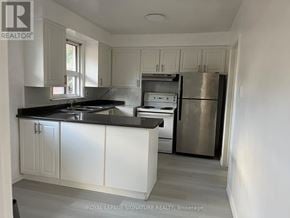Toronto (Tam O'shanter-Sullivan) apartment for rent - A kitchen with white cabinets and a stainless steel refrigerator.
