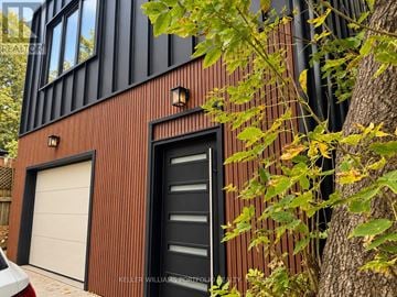 Toronto (Woodbine-Lumsden) apartment for rent - A modern house with a black door and a white garage door.
