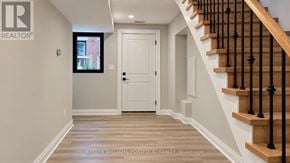 Toronto (Woodbine-Lumsden) apartment for rent - A hallway with a staircase and a door.