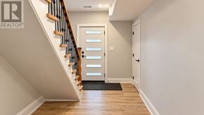Toronto (Woodbine-Lumsden) apartment for rent - A hallway with a staircase and a door.