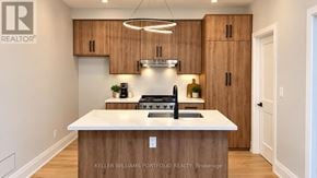 Toronto (Woodbine-Lumsden) apartment for rent - A modern kitchen with wooden cabinets and a white island.