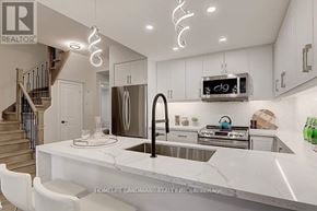 Markham (Unionville) condo for rent - A modern kitchen with a marble countertop and stainless steel appliances.