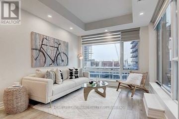 Markham (Unionville) condo for rent - A living room with a large painting of a bicycle on the wall.