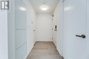 Mississauga (City Centre) condo for rent - A white hallway with a door on the right.