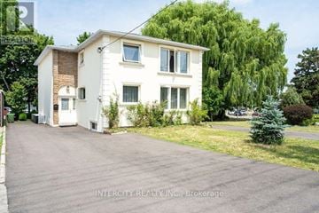 Toronto (Kingsview Village-The Westway) multi-family for rent - A white two-story house with a driveway in front.