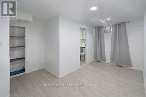 Toronto (Kingsview Village-The Westway) multi-family for rent - A white room with a grey curtain and a sign that says Intercity Realty Inc. Brokerage.