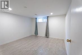 Toronto (Kingsview Village-The Westway) multi-family for rent - A room with a window and a door, with the text "INTERCITY REALTY INC., Brokerage" on the wall.