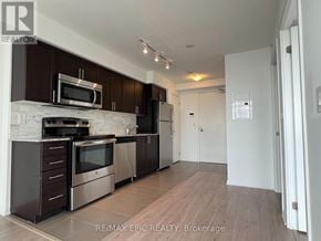 Toronto (Yorkdale-Glen Park) condo for rent - A modern kitchen with dark brown cabinets and stainless steel appliances.