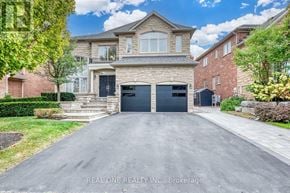 Oakville (Jc Joshua Creek) apartment for rent - A large, two-story house with a garage is surrounded by a well-maintained lawn and other residential homes.