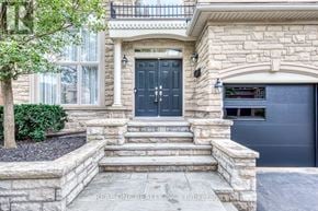 Oakville (Jc Joshua Creek) apartment for rent - A house with a black front door and a stone wall.