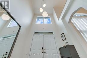 Oakville (Jc Joshua Creek) apartment for rent - A white door is in the middle of a hallway with a skylight above it.