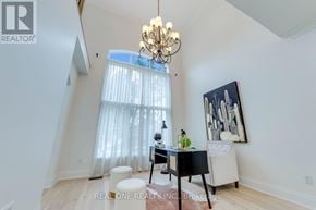 Oakville (Jc Joshua Creek) apartment for rent - A room with a desk, chair, and a chandelier.