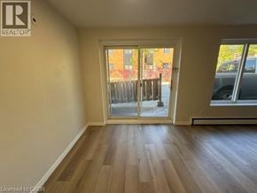 Kitchener apartment for rent - A room with a sliding glass door leading to a balcony.