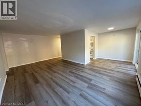 Kitchener apartment for rent - A room with wooden flooring and white walls.