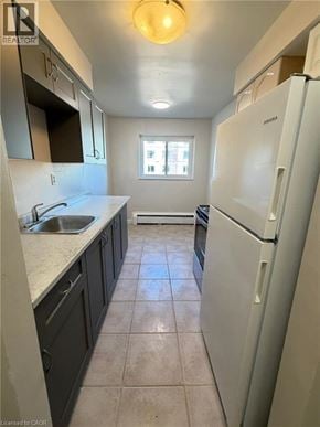 Waterloo apartment for rent - A kitchen with a white fridge and a window.