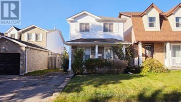 Oshawa (Pinecrest) apartment for rent - A row of houses with a sign that says Realtor.