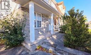 Oshawa (Pinecrest) apartment for rent - A house with a front porch and a small garden.