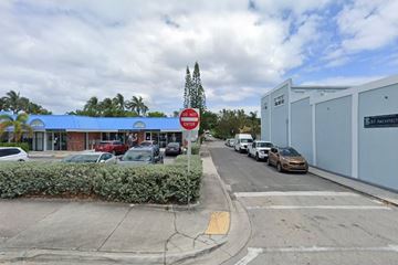West Palm Beach apartment for rent - A street view with a red stop sign and a blue building.