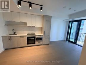 Toronto (Forest Hill South) condo for rent - A kitchen with wooden cabinets and a marble countertop.