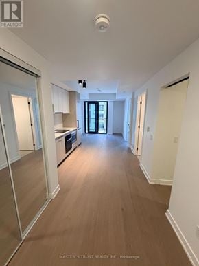 Toronto (Forest Hill South) condo for rent - A long hallway with a door at the end.