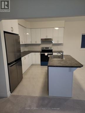 Brant (Paris) apartment for rent - A kitchen with white cabinets and a black countertop.