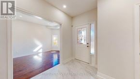 Newmarket (Gorham-College Manor) apartment for rent - A room with a wooden floor and white walls, with a door on the right.