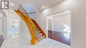 Newmarket (Gorham-College Manor) apartment for rent - A staircase with a yellow handrail and white steps leads to a second floor.