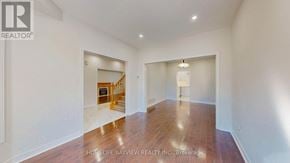 Newmarket (Gorham-College Manor) apartment for rent - A spacious room with wooden floors and white walls, part of a real estate listing.