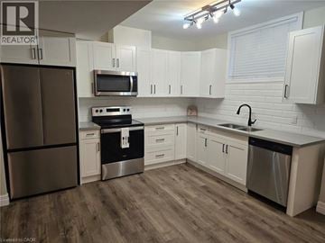 Cambridge apartment for rent - A kitchen with white cabinets and a refrigerator.