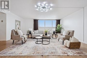 Guelph (Willow West/Sugarbush/West Acres) condo for rent - A living room with a large rug and a chandelier.