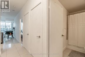 Mississauga (City Centre) condo for rent - A white door with a silver handle is in the center of a hallway.