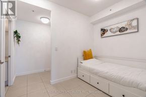 Mississauga (City Centre) condo for rent - A bedroom with a bed, nightstand, and a wall hanging picture.
