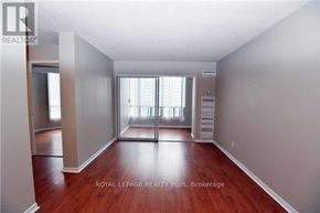 Mississauga (Cooksville) condo for rent - A room with wooden floors and a large window with blinds.