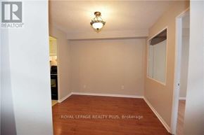 Mississauga (Cooksville) condo for rent - A room with a wooden floor and a chandelier hanging from the ceiling.