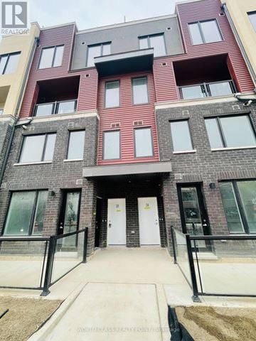 Mississauga (Erin Mills) townhouse for rent - A modern apartment building with a white door and black railings.