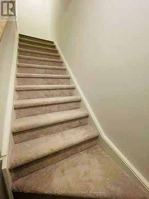 Mississauga (Erin Mills) townhouse for rent - A staircase with beige carpeted steps and white handrails.