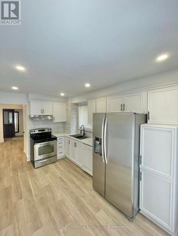 Brampton (Brampton West) apartment for rent - A modern kitchen with white cabinets and stainless steel appliances.