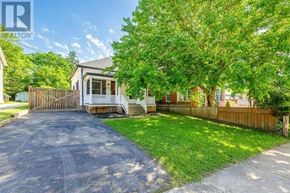 Niagara Falls (Downtown) apartment for rent - A house with a driveway and a tree in front of it.
