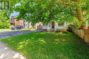 Niagara Falls (Downtown) apartment for rent - A tree in front of a house with a car parked in the driveway.