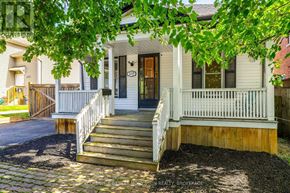 Niagara Falls (Downtown) apartment for rent - A white house with a black door and a porch.