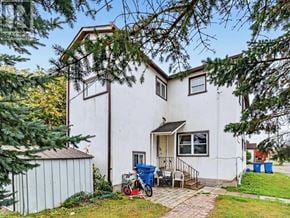 East Gwillimbury (Holland Landing) multi-family for rent - A white house with a blue trash bin and a red lawnmower in front.