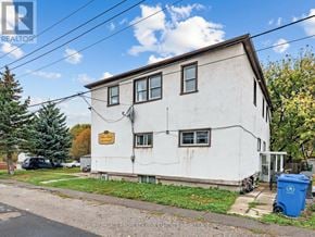 East Gwillimbury (Holland Landing) multi-family for rent - A white house with a blue trash can in front of it.